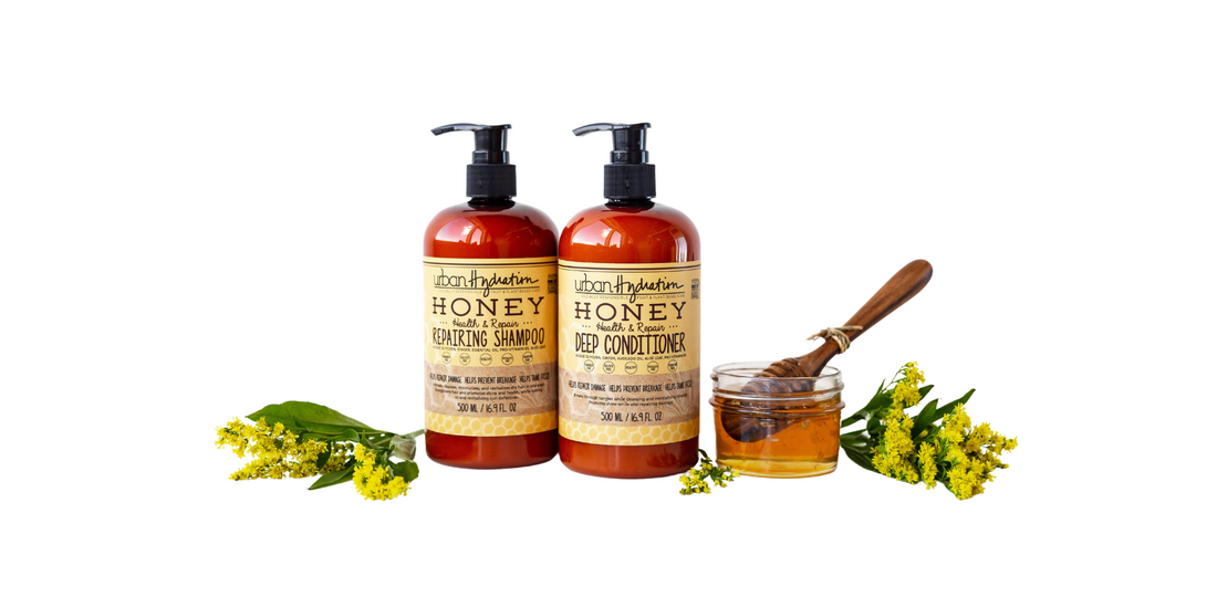 Urban Hydration Honey Health & Repair Shampoo and Deep Conditioner bottles with honey and yellow flowers, representing natural, inclusive beauty and plant-based haircare for all hair types
